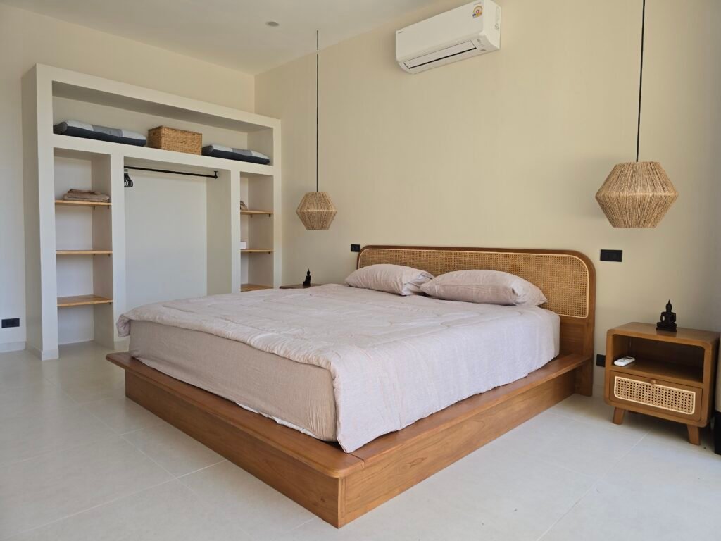 modern bedroom with wooden furniture in a luxury villa