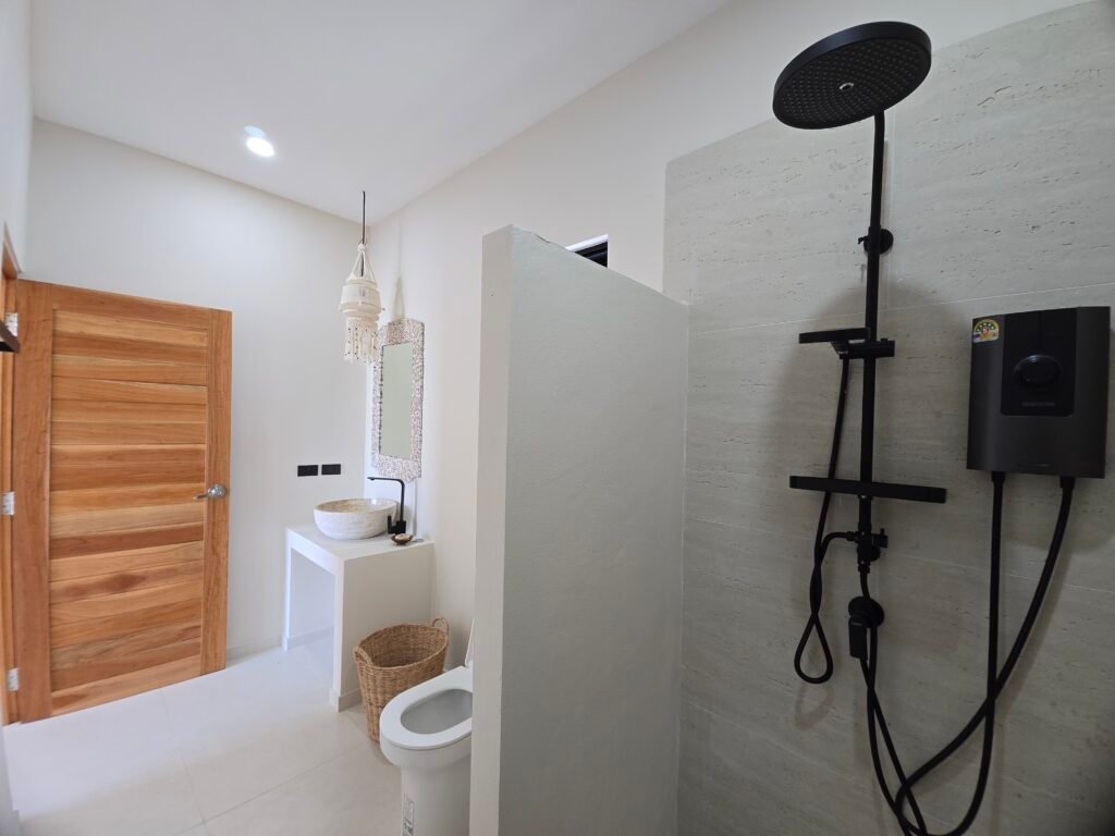 Bathroom with shower, wooden mirror, stone sink and refined decor
