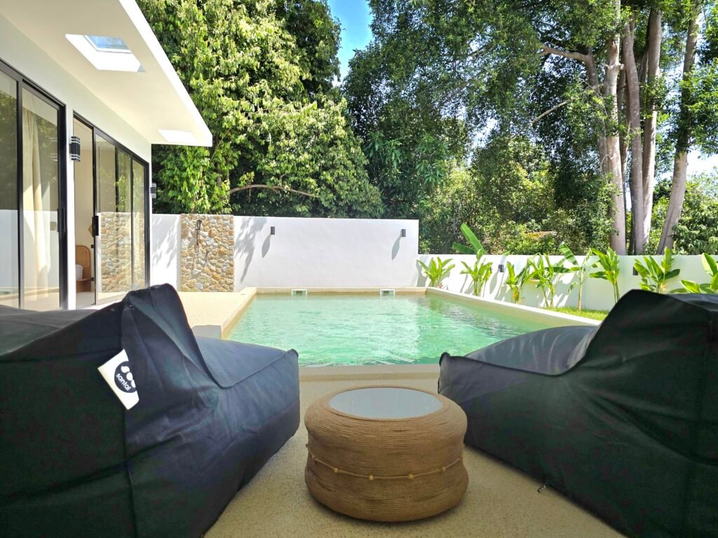 garden furniture on a covered terrace by the pool in a luxury house