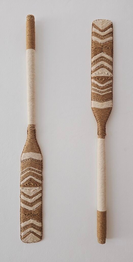 decorative paddle with a wood and white rope pattern